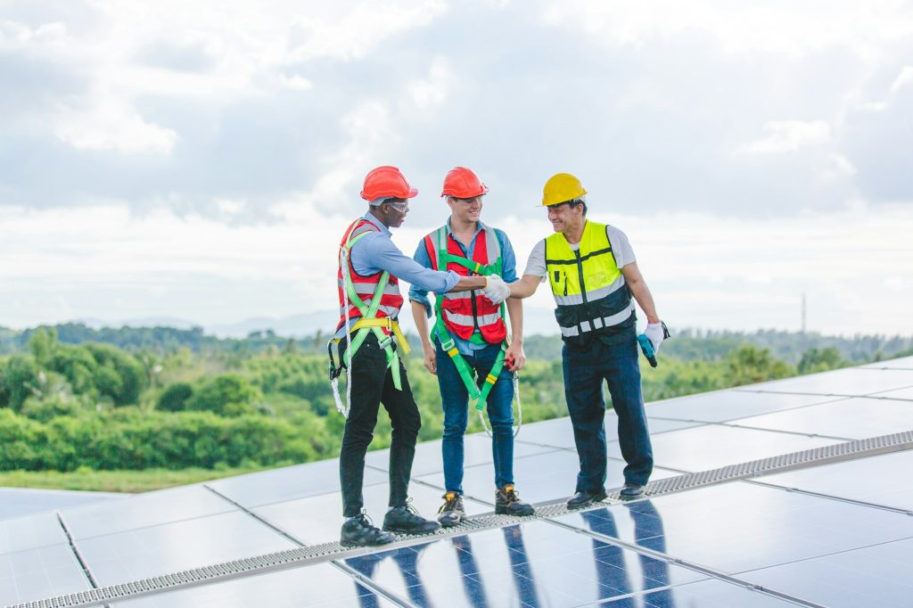 Technician engineer setting solar panel on roof of building to work at full efficiency