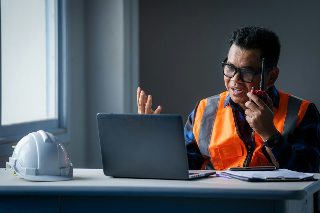 Engineer working with laptop computer in builders at construction site,Industry.