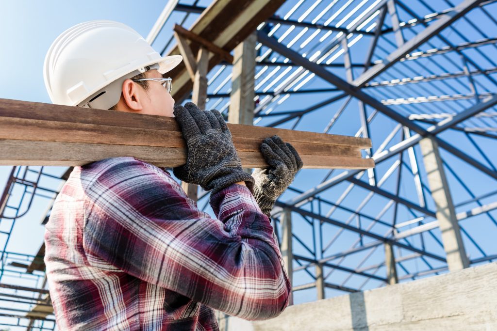 Foreman holding roof tiles for checking before thatched on the top roof tiles concept construction